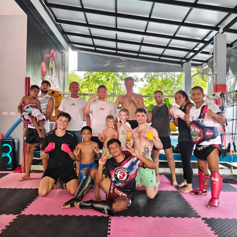 Children, adults and E.N. Muaythai Gym team members together inside the gym